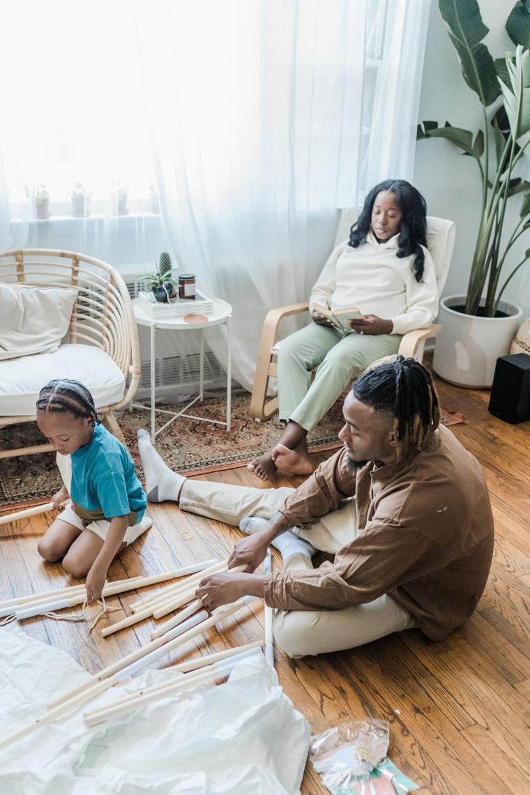 A mother and her children learning about money together at home
